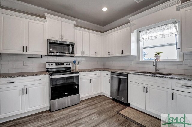 kitchen featuring white cabinetry, appliances with stainless steel finishes, sink, and stone countertops