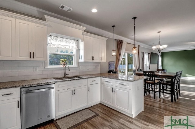 kitchen featuring white cabinets, sink, stainless steel dishwasher, and kitchen peninsula