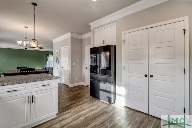 kitchen featuring white cabinets, pendant lighting, dark hardwood / wood-style flooring, and fridge