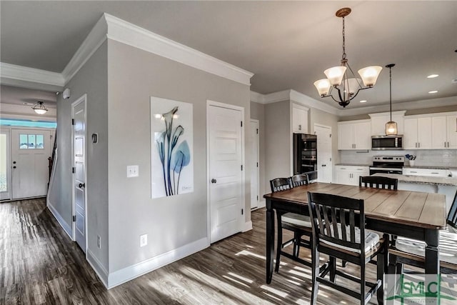 dining area featuring crown molding, a chandelier, and dark wood-type flooring