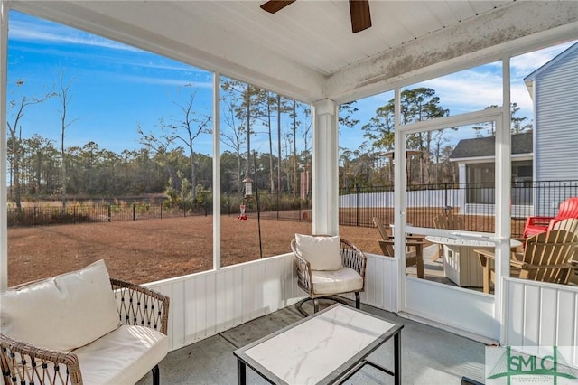 sunroom featuring ceiling fan