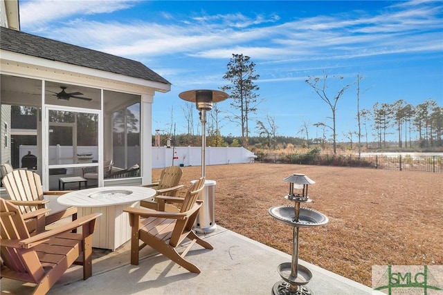 view of patio with ceiling fan and a sunroom