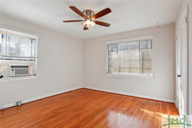 spare room with light wood-type flooring, ceiling fan, and cooling unit