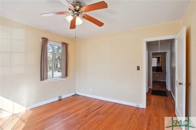 empty room with ceiling fan and wood-type flooring