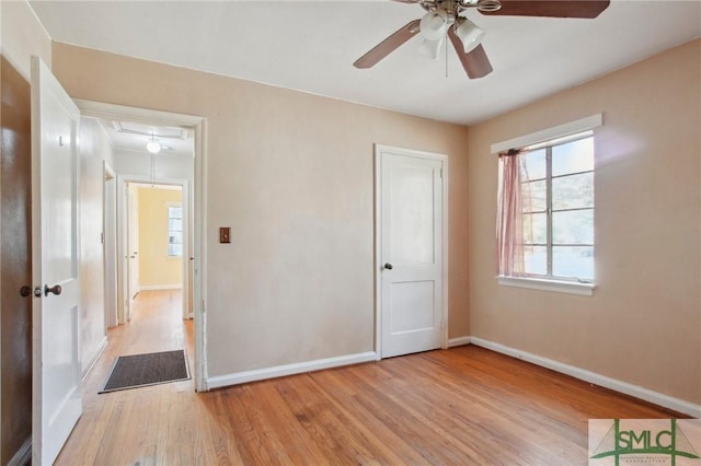 unfurnished bedroom with ceiling fan and light hardwood / wood-style flooring