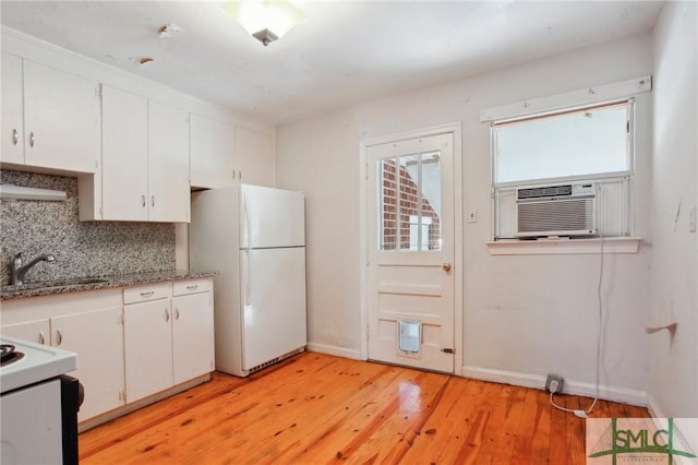 kitchen featuring decorative backsplash, sink, white cabinetry, light wood-type flooring, and white refrigerator