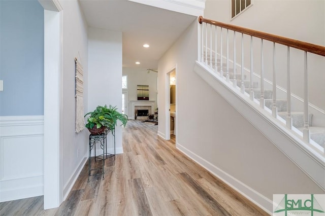 hall with stairway, wood finished floors, visible vents, and recessed lighting