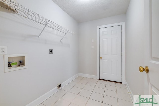 clothes washing area featuring hookup for a washing machine, hookup for an electric dryer, a textured ceiling, laundry area, and baseboards