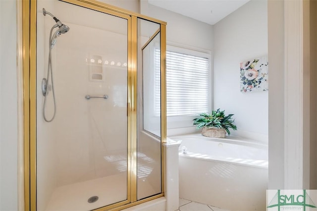 bathroom with a stall shower and a bath