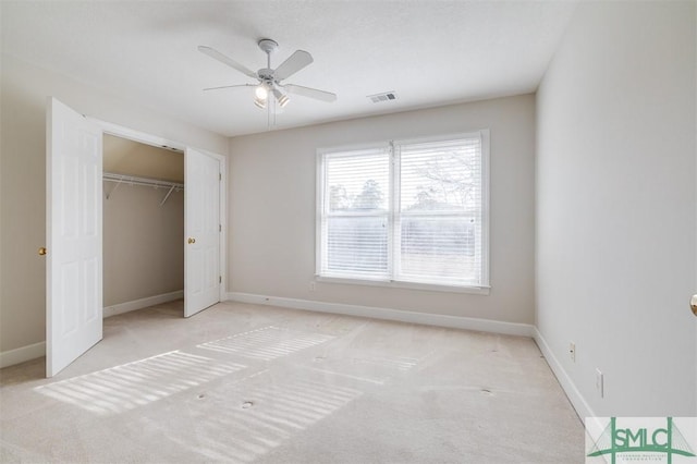 unfurnished bedroom with carpet, visible vents, baseboards, and a closet