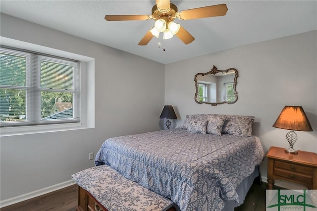 bedroom with dark wood-type flooring and ceiling fan