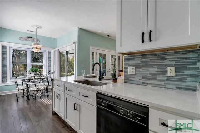 kitchen featuring dishwasher, french doors, hanging light fixtures, white cabinets, and sink