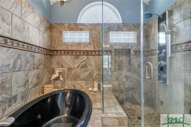 bathroom featuring separate shower and tub