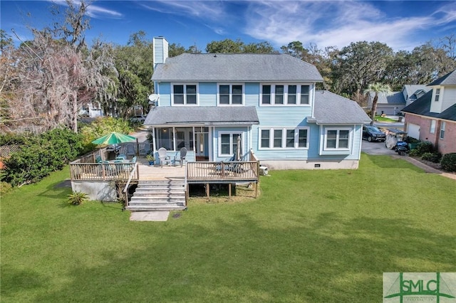 back of house featuring a yard and a wooden deck