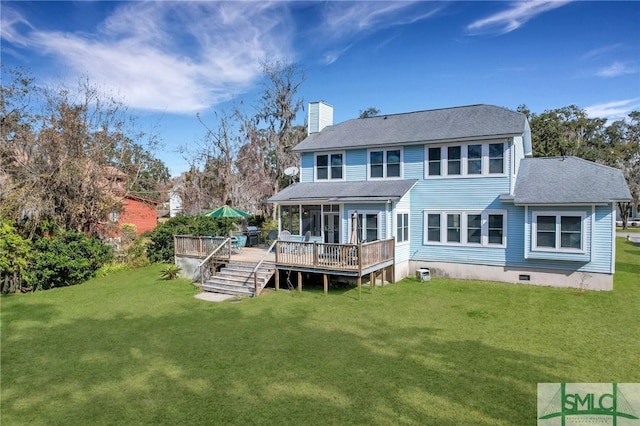 back of property featuring a deck and a yard