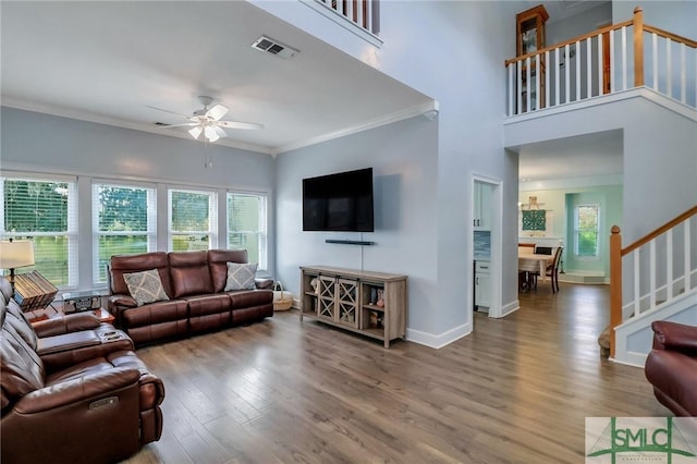 living room with ceiling fan, hardwood / wood-style floors, and ornamental molding