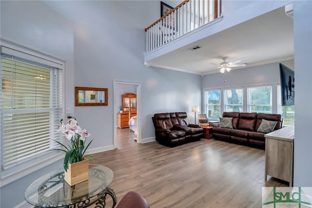 living room with ceiling fan, hardwood / wood-style floors, and crown molding