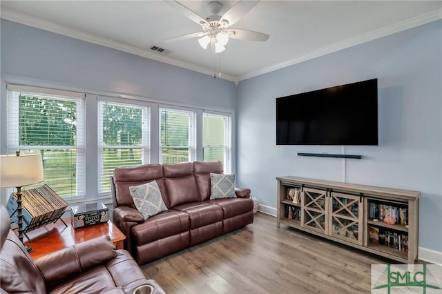 living room featuring ceiling fan, ornamental molding, and hardwood / wood-style floors