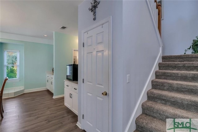 stairs with hardwood / wood-style flooring