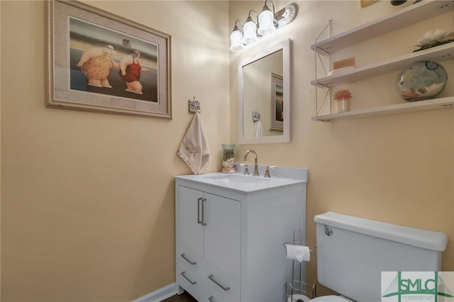 bathroom featuring toilet and vanity