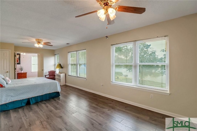 bedroom with ceiling fan and dark hardwood / wood-style flooring