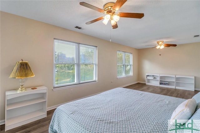 bedroom featuring ceiling fan and dark wood-type flooring