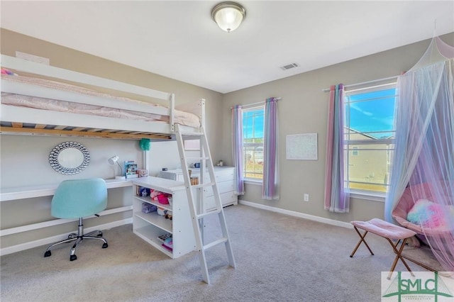 carpeted bedroom featuring baseboards and visible vents