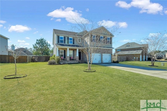 traditional home featuring an attached garage, fence, a front lawn, and concrete driveway