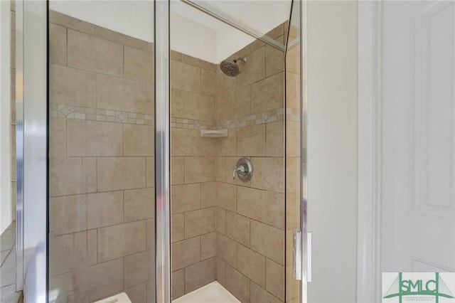 bathroom featuring a shower with shower door