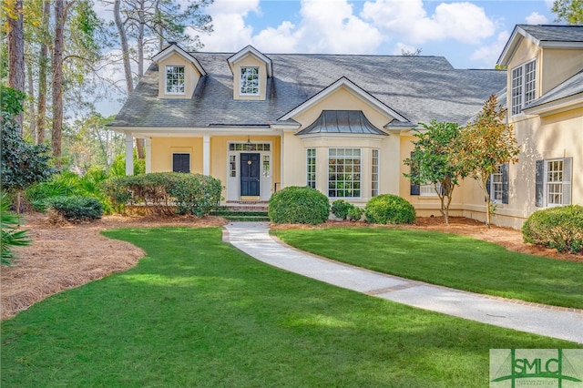 new england style home featuring a front lawn