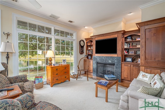 carpeted living room with a premium fireplace and crown molding