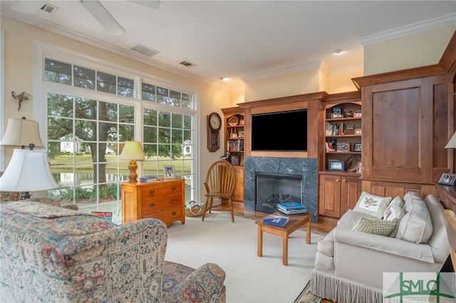 living room with light colored carpet, a fireplace, and ornamental molding