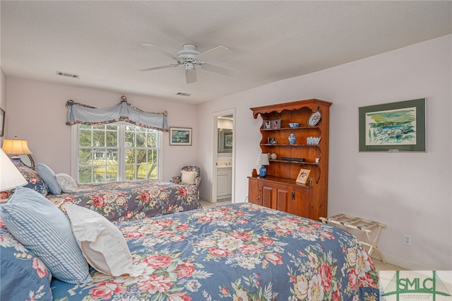 carpeted bedroom featuring a textured ceiling, ceiling fan, and ensuite bath