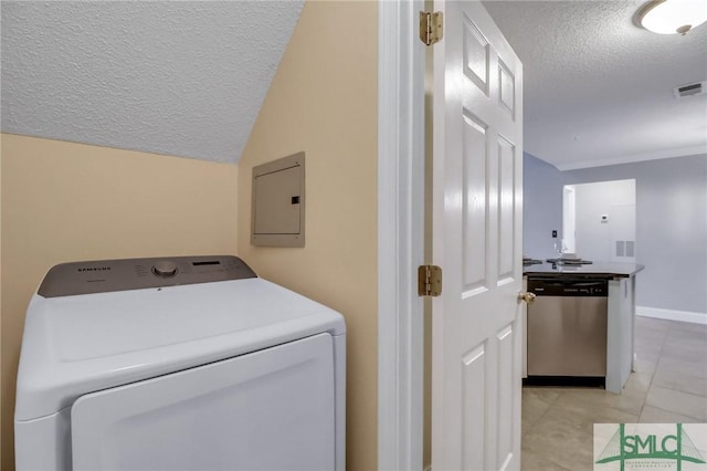 laundry area featuring light tile patterned flooring, washer / dryer, a textured ceiling, and electric panel