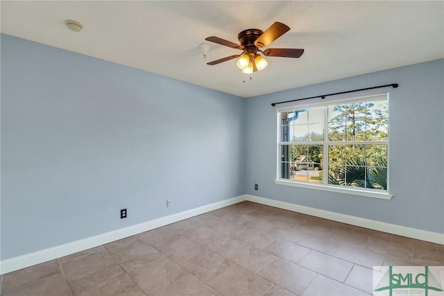 spare room featuring ceiling fan and light tile patterned floors