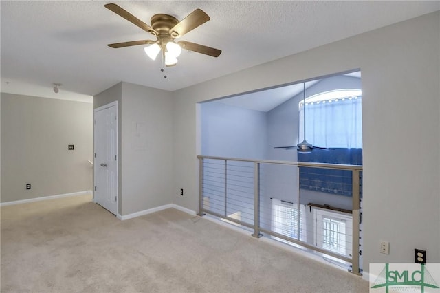 carpeted empty room with ceiling fan