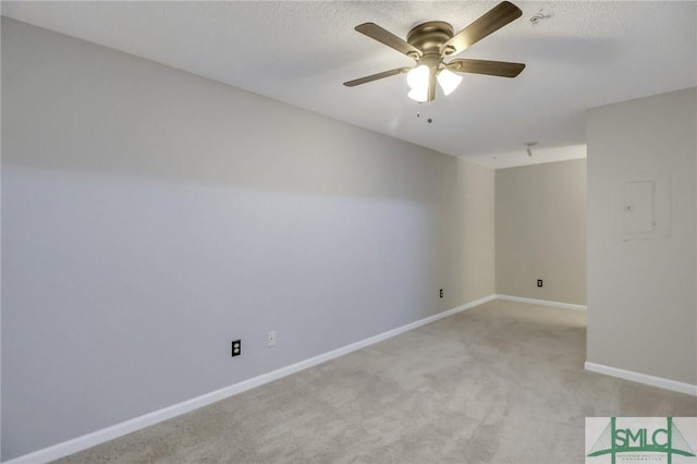 spare room featuring ceiling fan and light colored carpet