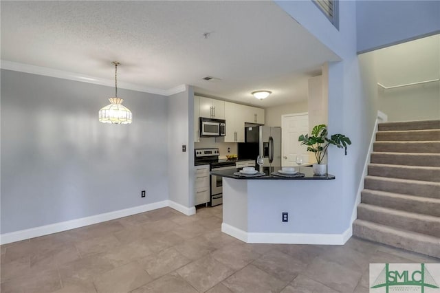 kitchen featuring kitchen peninsula, crown molding, white cabinetry, hanging light fixtures, and stainless steel appliances