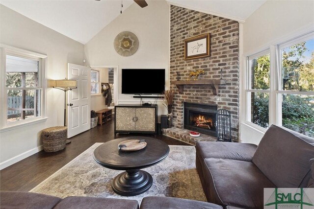 living room with ceiling fan, dark hardwood / wood-style flooring, high vaulted ceiling, and a fireplace