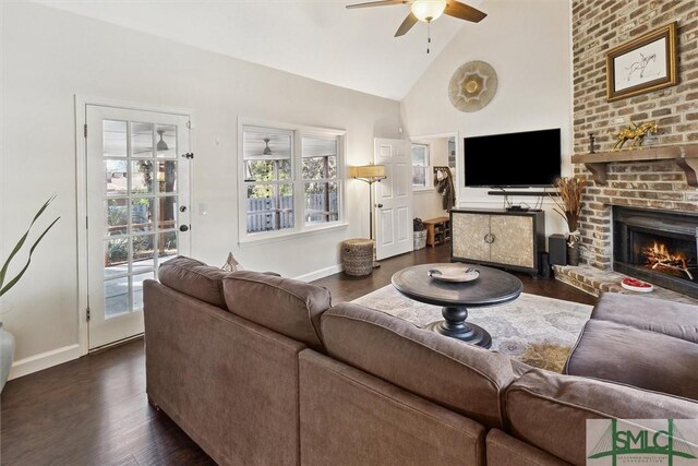 living room with dark wood-type flooring, plenty of natural light, ceiling fan, and a fireplace