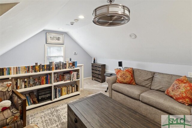 living room featuring vaulted ceiling and carpet floors