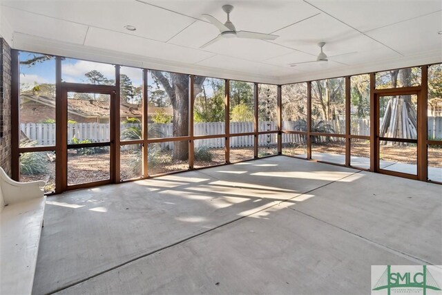 unfurnished sunroom with ceiling fan and plenty of natural light