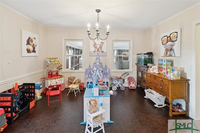 rec room with dark wood-type flooring, an inviting chandelier, and ornamental molding