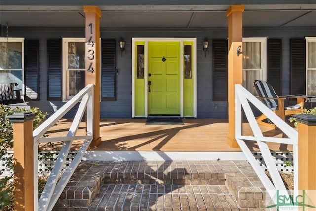 view of exterior entry with covered porch