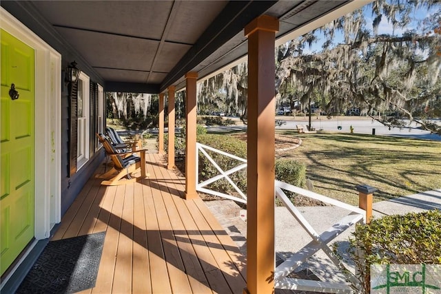 wooden deck with a porch and a yard