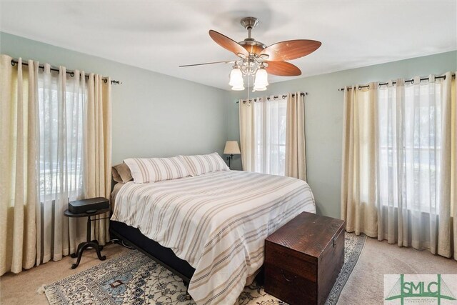 bedroom with ceiling fan and light carpet