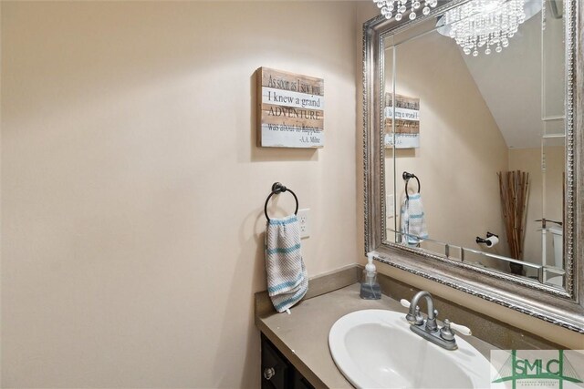 bathroom with vanity and a notable chandelier