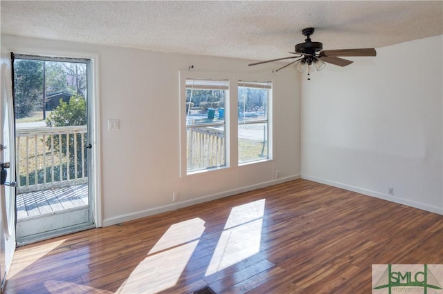 empty room featuring ceiling fan, a textured ceiling, and hardwood / wood-style floors