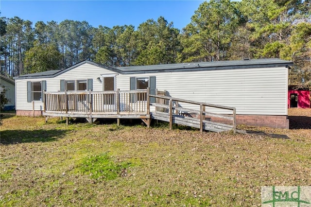 back of house with a deck and a yard