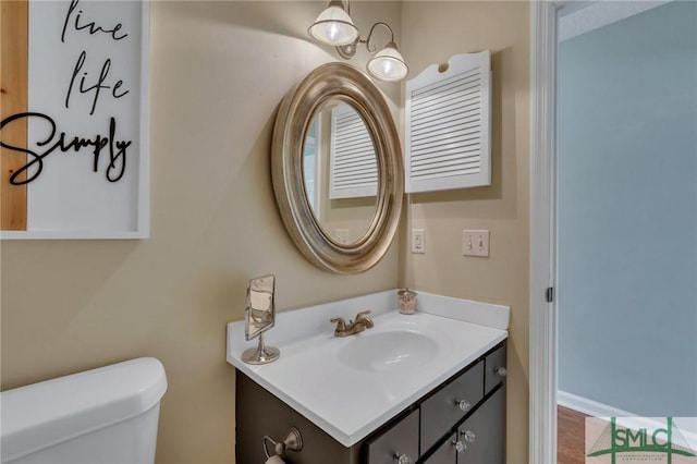 bathroom with toilet and vanity